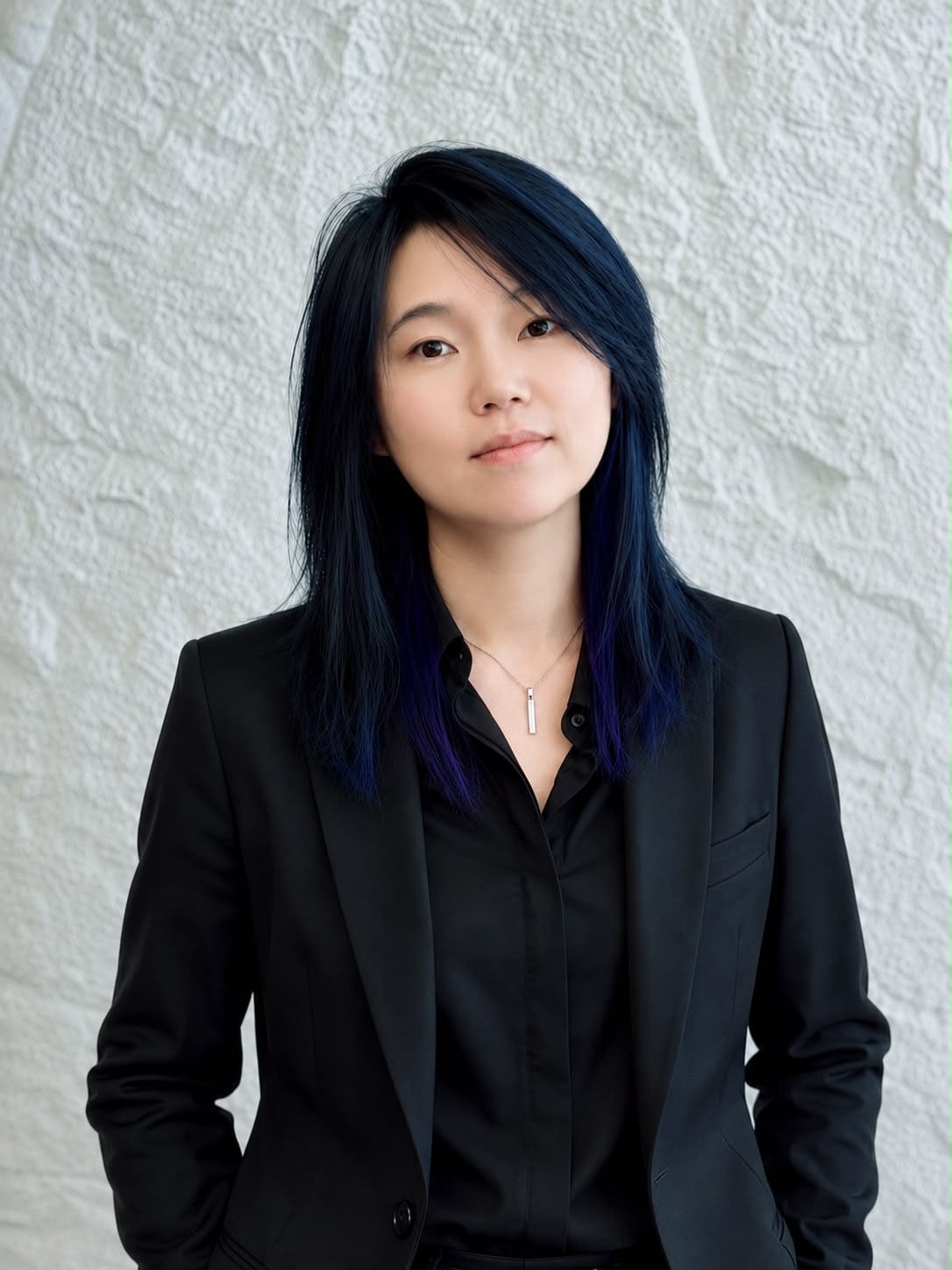 JM, senior hair stylist at Salon Era Vancouver, portrait with blue-black highlighted hair